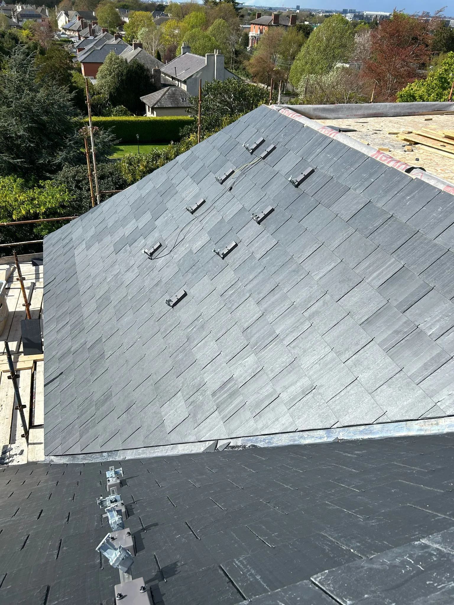 New Spanish slates on a new roof, solar panel brackets fitted — photo 1