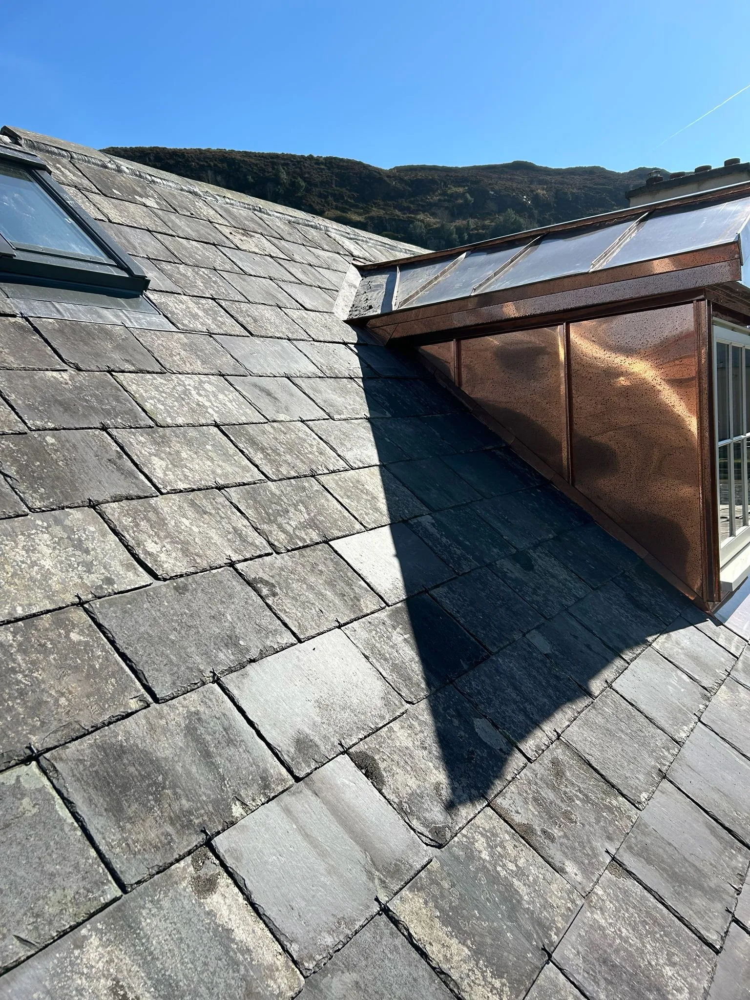 Existing slates being re-used on a farm roof — photo 2