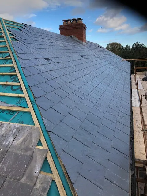 Roof being replaced. Existing Bangor slates on the front and side slopes. New Spanish slates on the back — photo 13