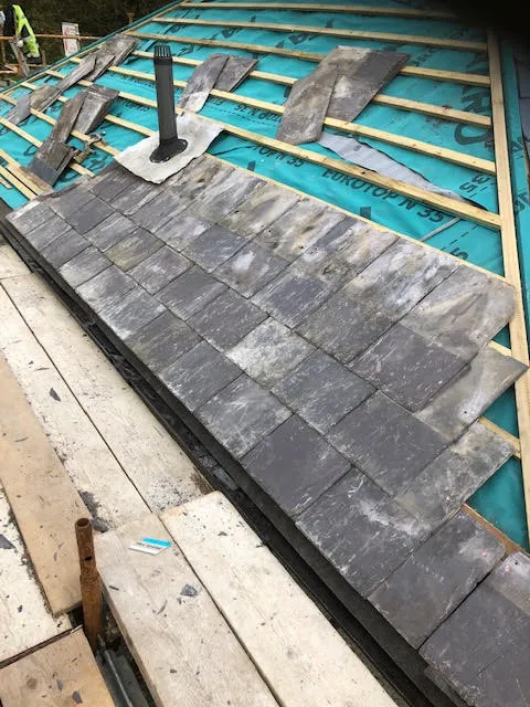 Roof being replaced. Existing Bangor slates on the front and side slopes. New Spanish slates on the back — photo 14