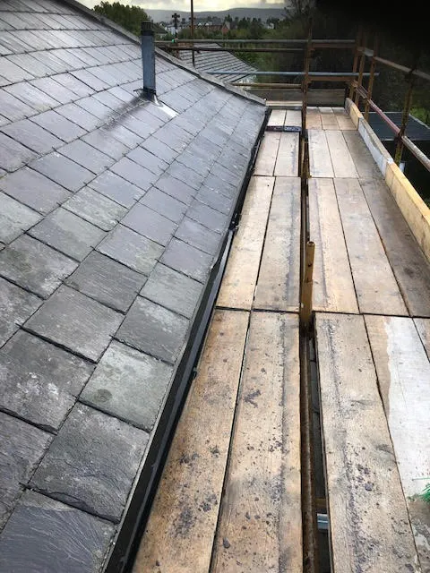 Roof being replaced. Existing Bangor slates on the front and side slopes. New Spanish slates on the back — photo 24